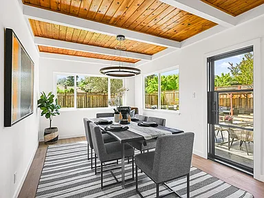 whole home remodel dining room with wood ceiling and patio doors