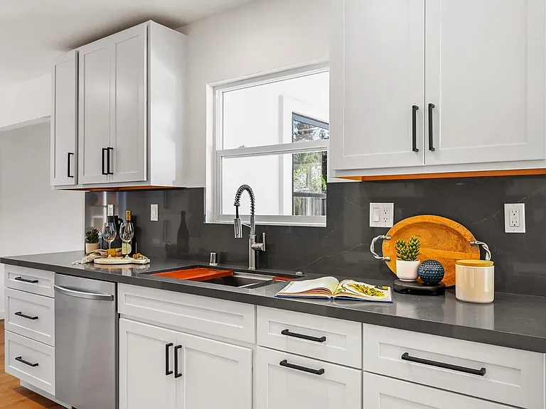 whole home remodel kitchen with white cabinets and dining area