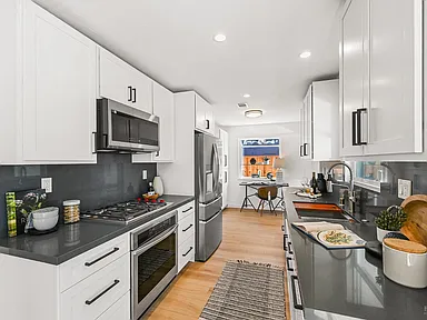 updated kitchen with black counters and white cabinets